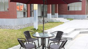 Premium Patio Set with Glass-Top Table, Ergonomic Chairs, and Red Umbrella